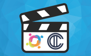 A film clapper board on a blue background. The clapper board has the Inlcusion BC and Canadian Institute for Inclusion and Citizenship logos on it